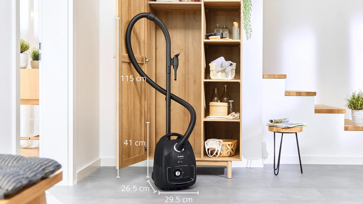 Bosch Series 4 ProEco BGL38BA3GB black vacuum cleaner with hose and dimensions shown in a modern living space