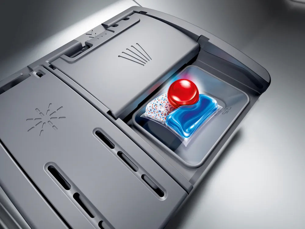 Close-up of Bosch Series 6 dishwasher detergent dispenser with detergent pod inside in brushed steel finish.