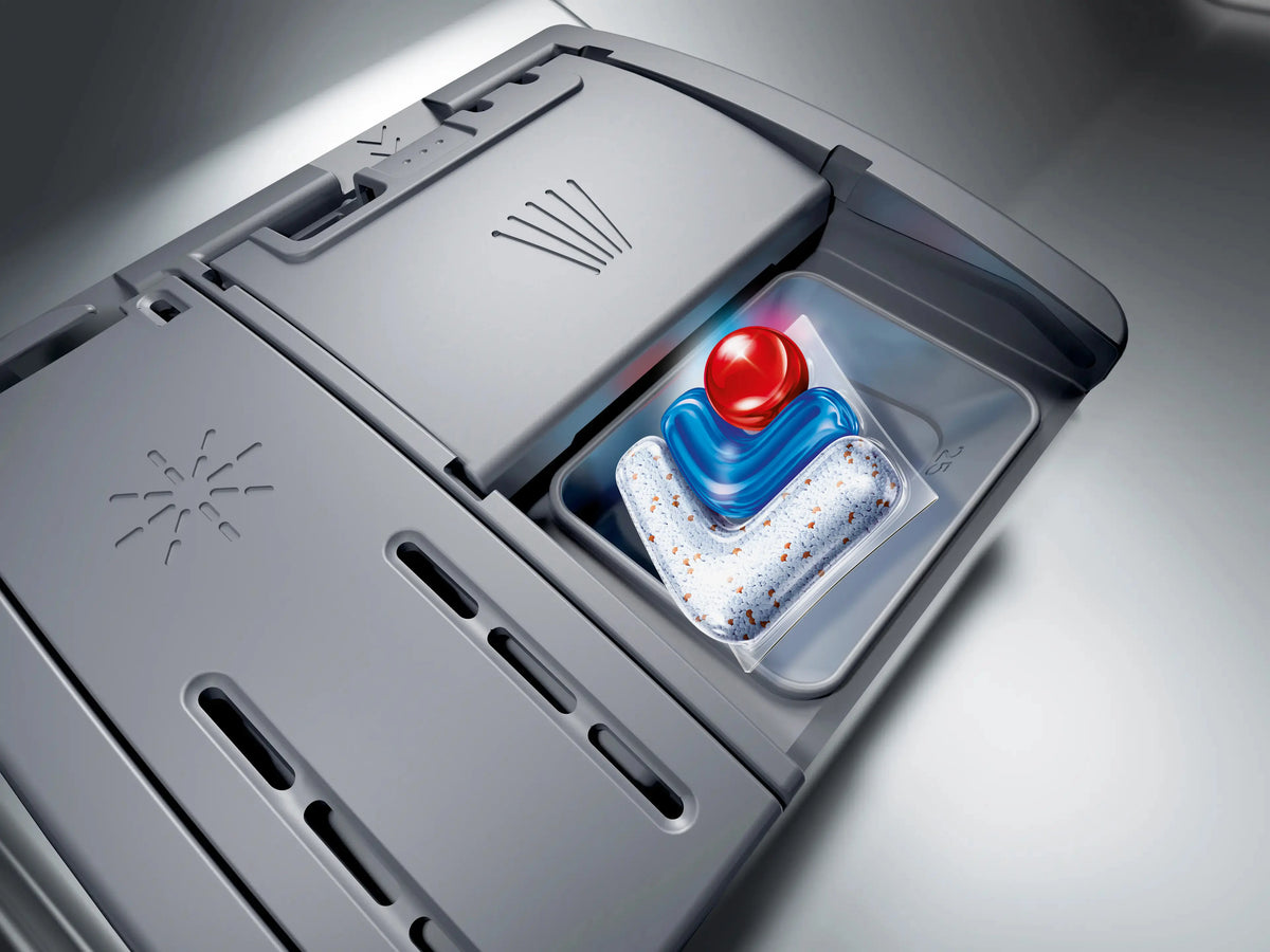 Close-up of Bosch Series 4 dishwasher detergent dispenser with a colorful detergent pod inside.