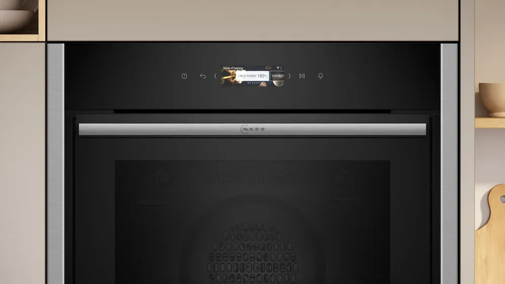 Built-in NEFF N70 Slide&Hide electric oven in stainless steel with digital display and hidden sliding door.