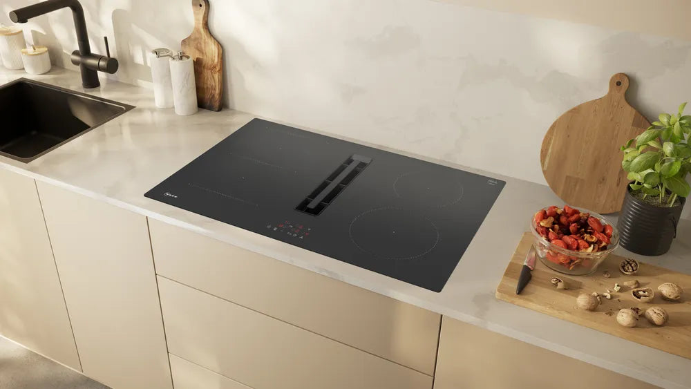 Neff N50 black induction hob with integrated ventilation installed in a modern kitchen countertop