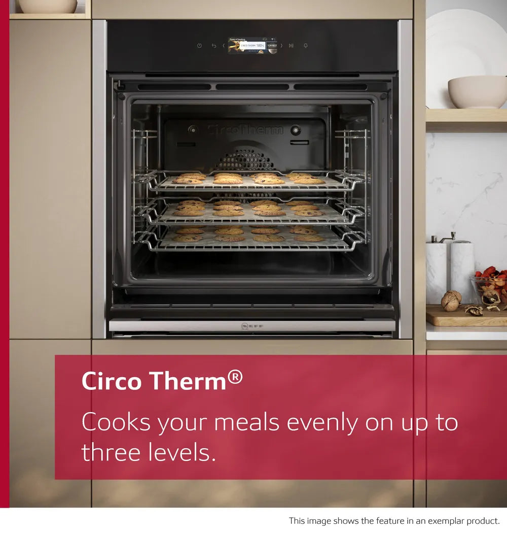 NEFF N70 Slide&Hide oven with three racks baking cookies evenly inside a modern kitchen setting.