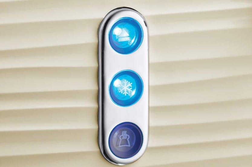 Close-up of three blue function buttons on the cream Russell Hobbs Inspire 4 slice toaster.