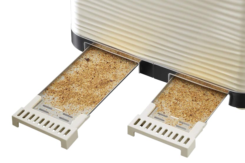 Close-up of crumb trays pulled out from the base of the Russell Hobbs Inspire Cream 4 Slice Toaster