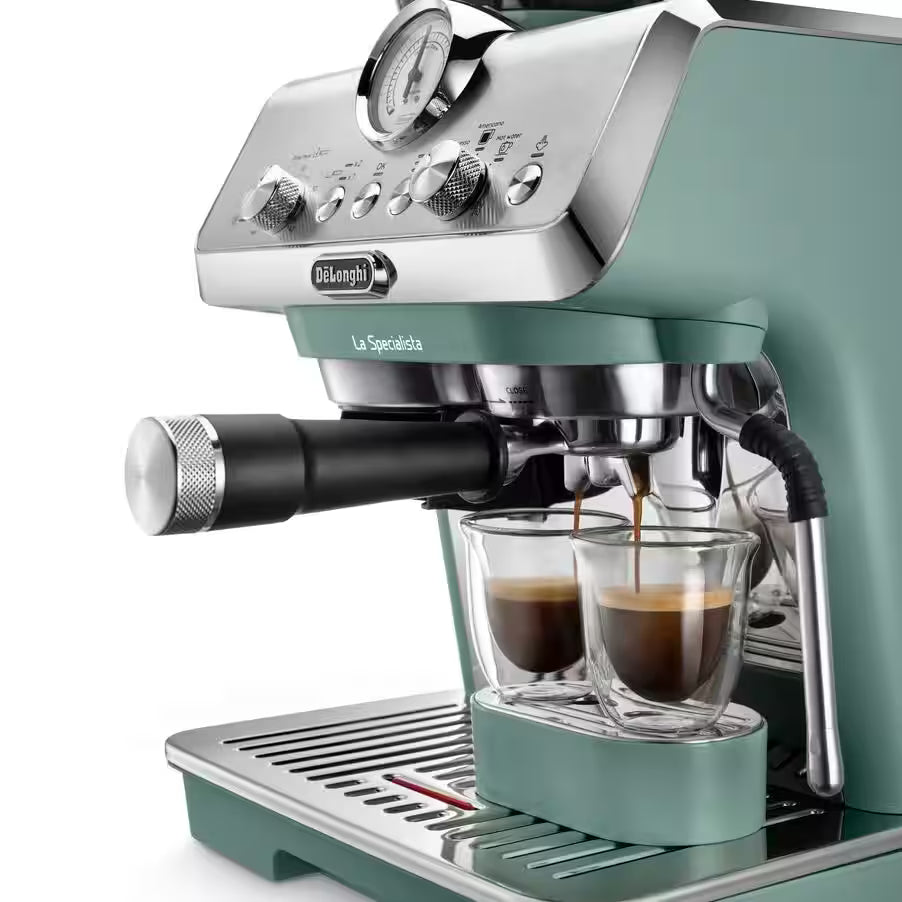 DeLonghi La Specialista Arte espresso machine in green brewing two shots into clear glass cups.