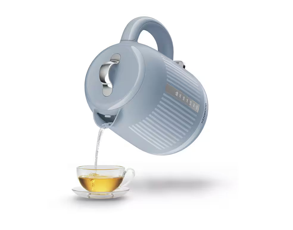 Kenwood Dawn Collection blue kettle pouring hot water into a glass teacup on a white background