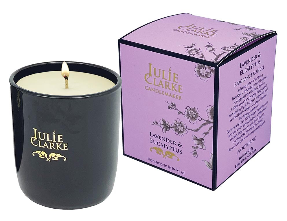 Julie Clarke Nocturne Lavender & Eucalyptus candle lit in black glass with purple floral packaging box.