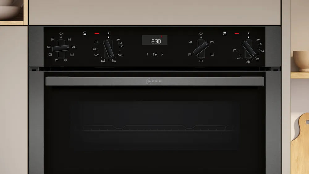 Neff N50 CircoTherm double oven in graphite with control knobs and digital clock display at 12:30.