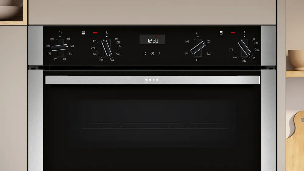 Neff N50 CircoTherm double oven in stainless steel with control knobs and digital clock display at 12:30.