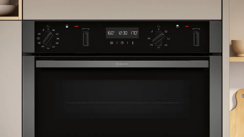 Neff 50 built-in double oven with black glass front, control knobs, and digital display showing temperature and time.