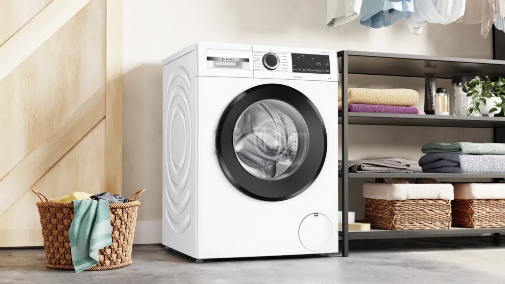 Bosch 10kg washing machine with black door, digital display, and control dial in a laundry room setting