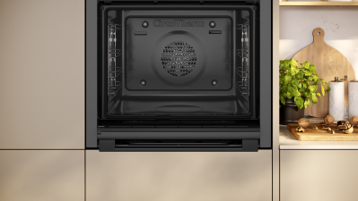NEFF Graphite N50 Slide & Hide single oven with open door showing clean interior and fan at the back.