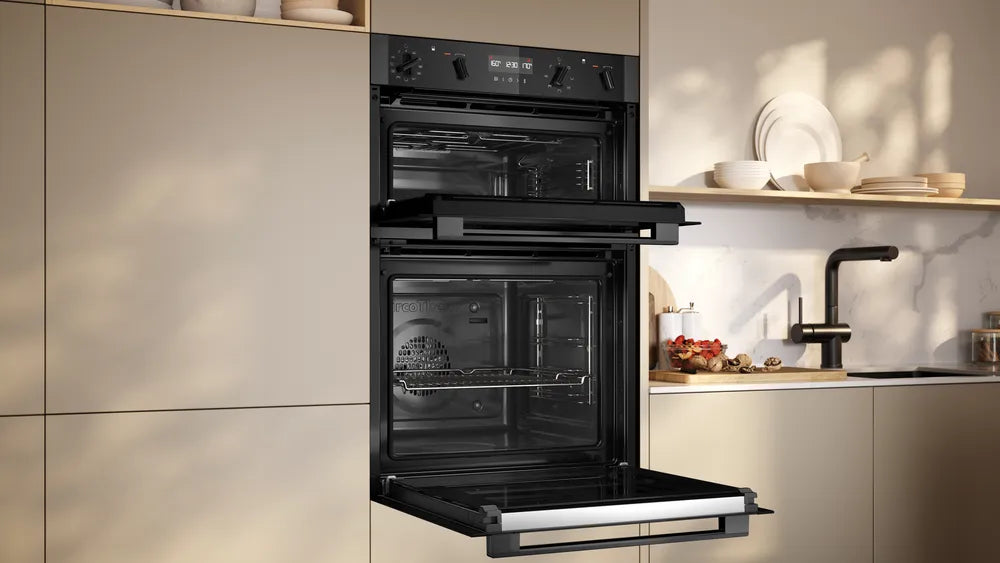 Built-in Neff 50 double oven with both doors open, installed in a modern kitchen setting.