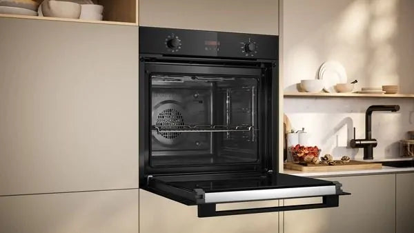 Neff B2DCG7AK3B built-in black electric oven with open door, showing interior and control knobs.