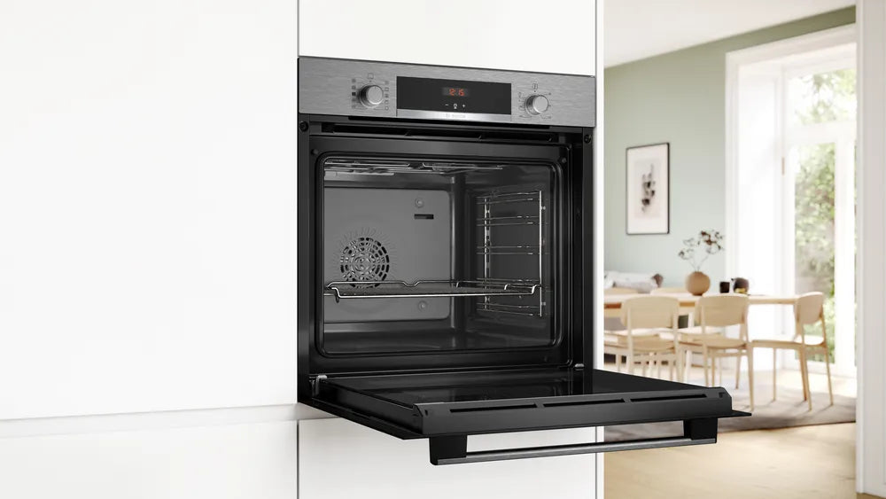 Bosch single oven in stainless steel with open door showing interior racks and digital display panel