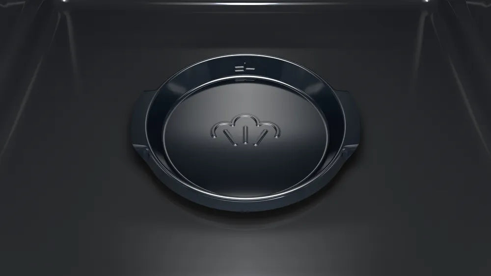 Close-up of the Bosch Single Oven stainless steel circular drip tray with embossed chef hat logo inside the oven cavity.