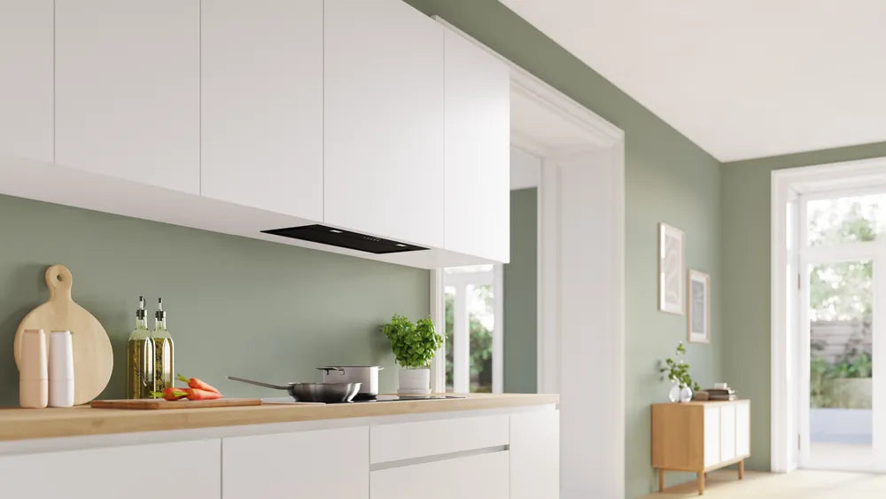 Bosch Series 6 black canopy cooker hood installed under white kitchen cabinets above a stovetop.