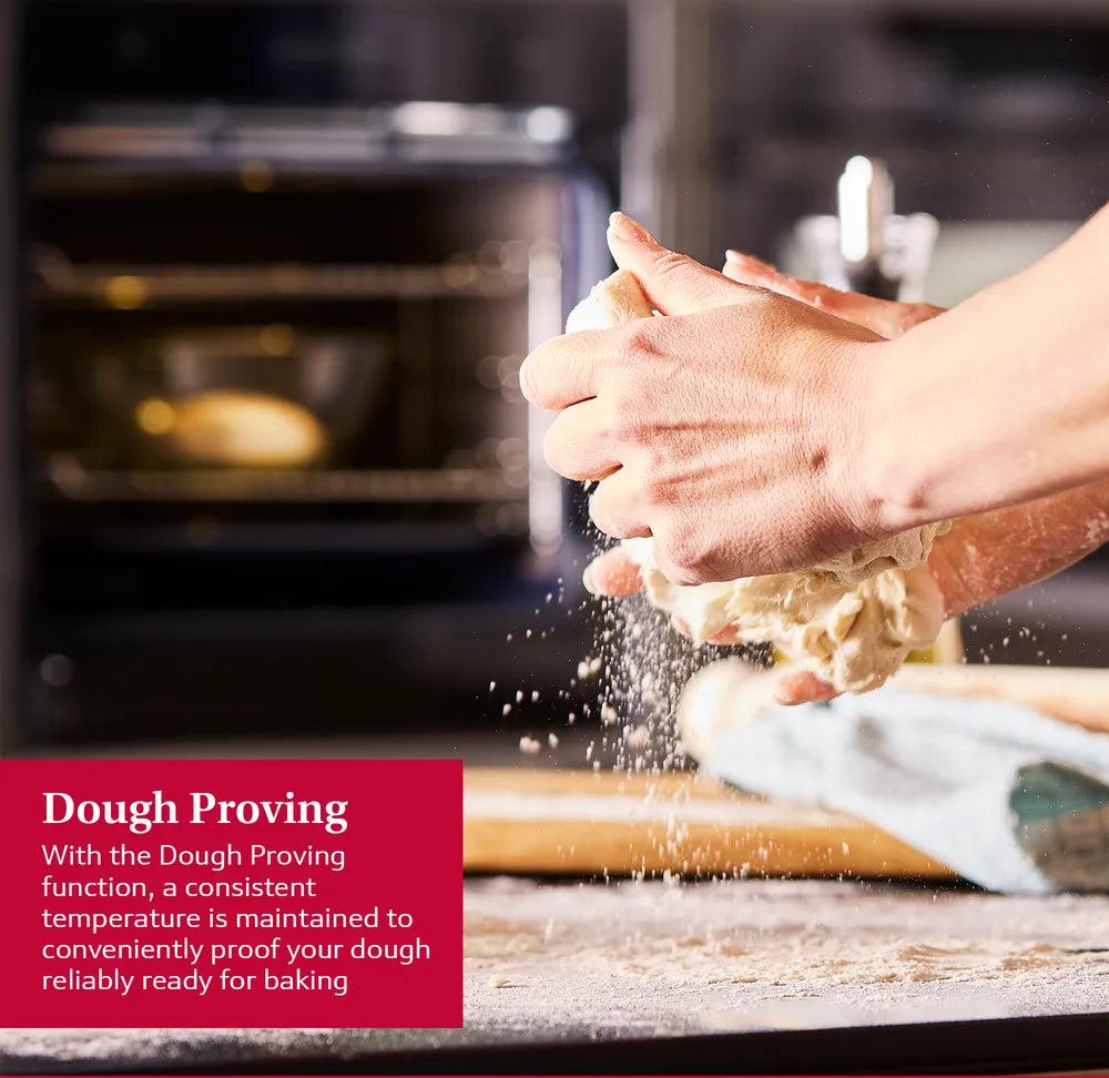 Hands kneading dough with flour falling, NEFF N70 Slide&Hide oven visible in the background