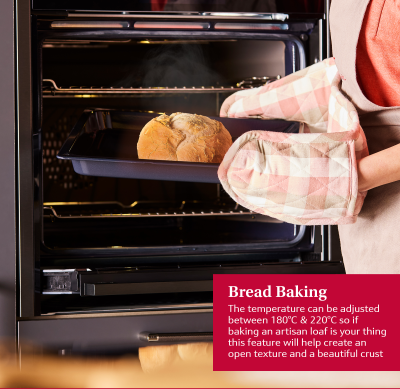 NEFF Graphite N50 Slide & Hide oven with person removing freshly baked bread using oven gloves