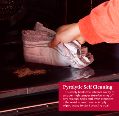 Hand wiping the clean interior of a NEFF Graphite N50 Slide & Hide oven after pyrolytic self-cleaning cycle.