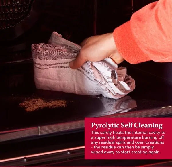 Hand wiping residue inside the Neff B2DCG7AK3B built-in electric oven with a cloth, highlighting pyrolytic cleaning.