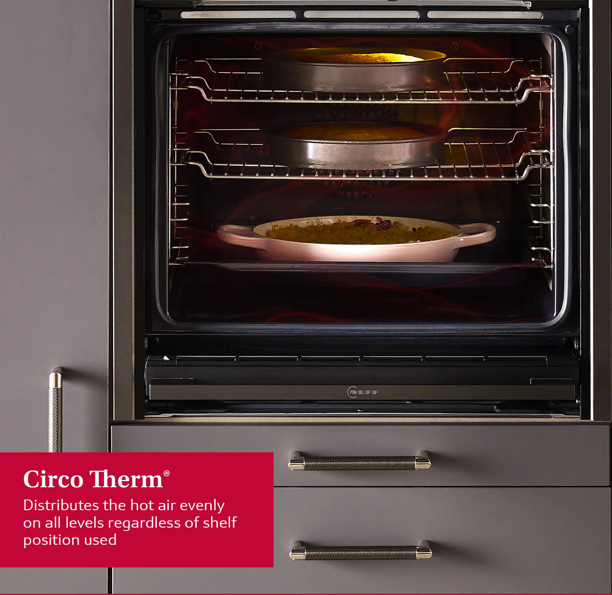 Neff N30 B1DCC0AK3B black electric oven with two cakes and a casserole dish inside on three shelves