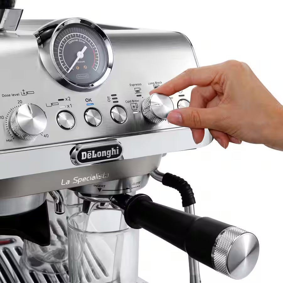Close-up of DeLonghi La Specialista Arte Evo espresso machine with hand adjusting a control knob.