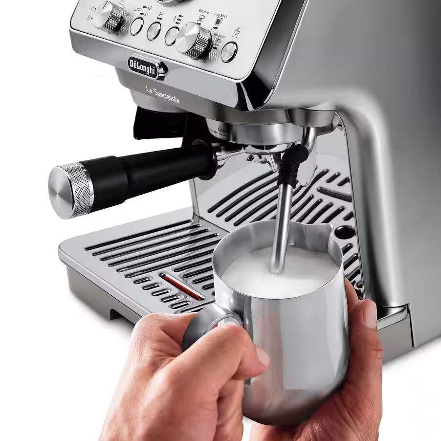 DeLonghi La Specialista Arte Evo espresso machine steaming milk in a stainless steel frothing pitcher.