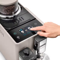 Person interacting with a coffee machine's touch screen interface