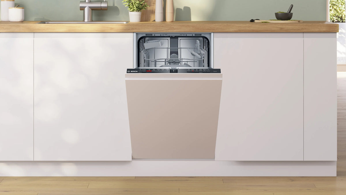 Bosch Series 2 fully integrated 45cm dishwasher with door panel matching white kitchen cabinets, open and empty interior