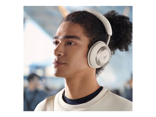 Person wearing white Soundcore Space One Pro headphones in a bright indoor setting