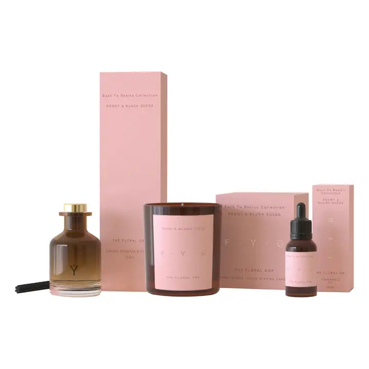 Peony & Blush Suede diffuser set with brown glass bottle, pink labels, and matching pink packaging boxes.