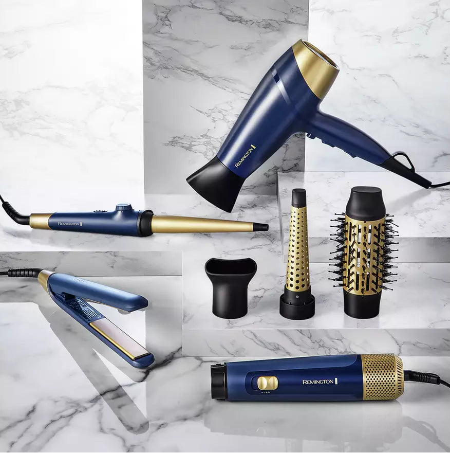 Remington Sapphire hair straightener in blue and gold with styling attachments on marble surface