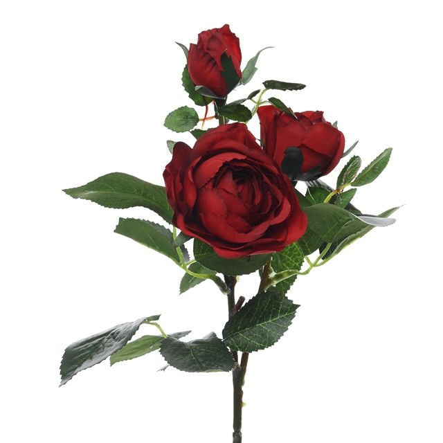 Red artificial rose spray with three blooms and green leaves on a single stem against white background.