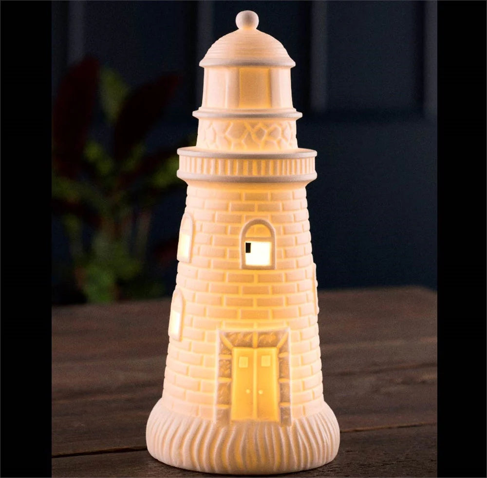 Luminaire Lighthouse LED glowing warm white with detailed brick texture on wooden surface