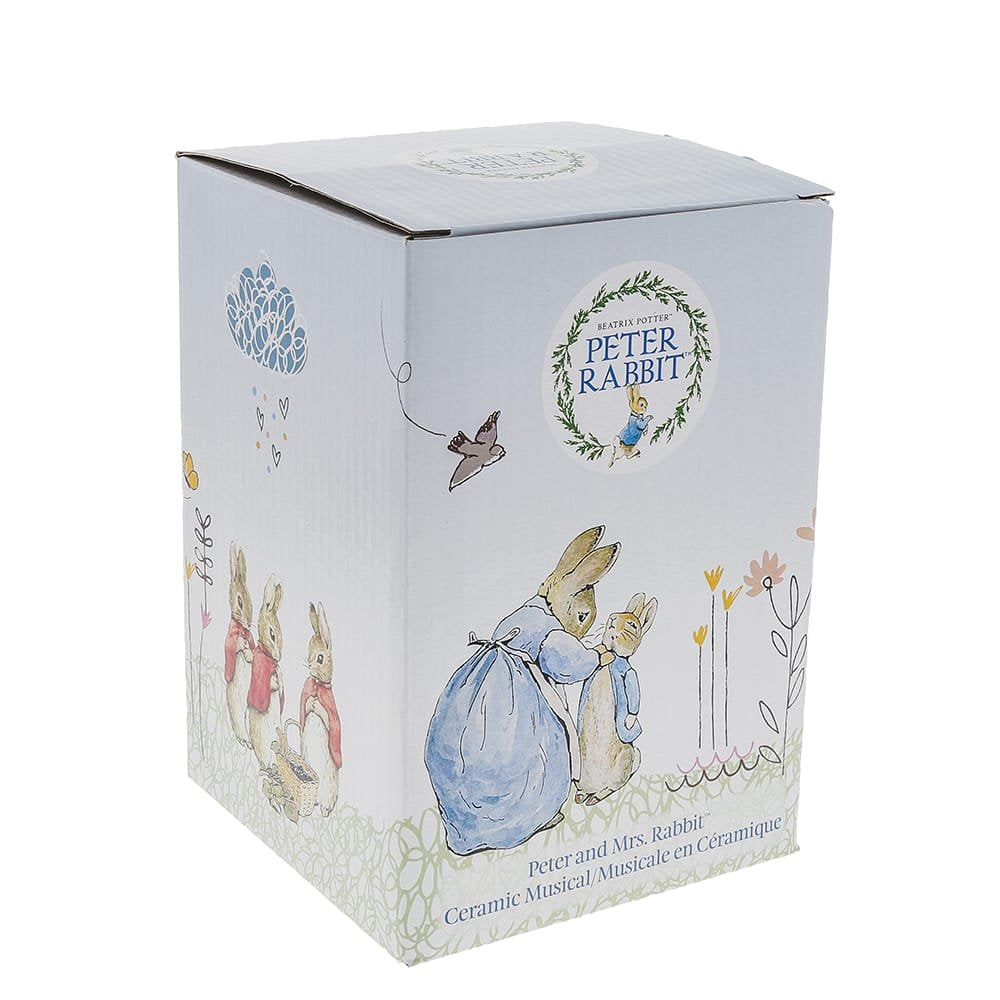 Box packaging for Peter Rabbit ceramic musical figurine featuring illustrated rabbits and floral designs.