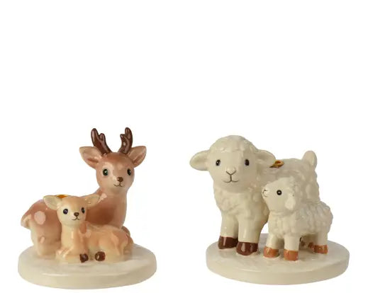 Two small ceramic farm animal figurines on round bases: a deer with fawns on the left and a lamb with a sheep on the right, photographed against a plain white background.