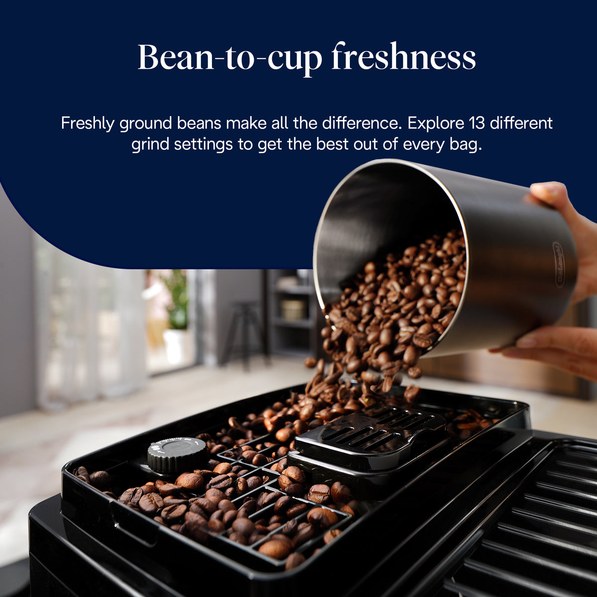 Close-up of coffee beans being poured into the bean container of the DeLonghi Magnifica Start coffee machine.
