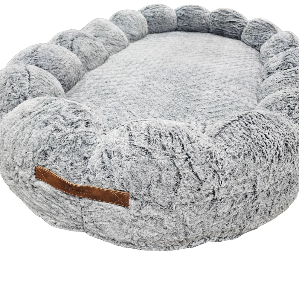 Alice & Co Beverley Bed in grey with plush, rounded bolsters and soft textured fabric.