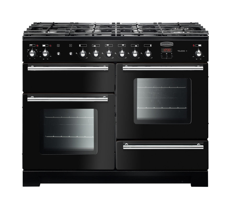 Rangemaster Toledo + 110 dual fuel range cooker in black with six gas burners and two electric ovens.