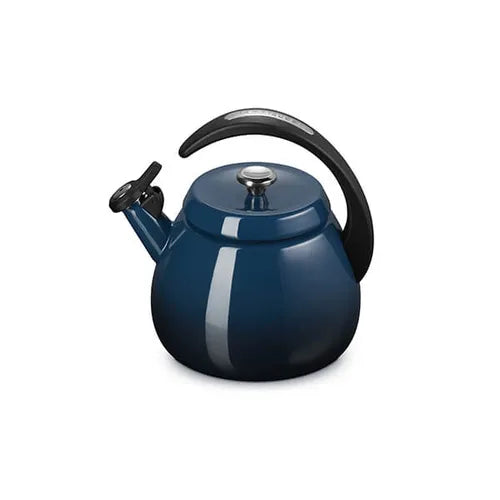 Le Creuset Cloche Kettle 2.1L in Nuit blue with curved black handle and silver lid knob, angled view.