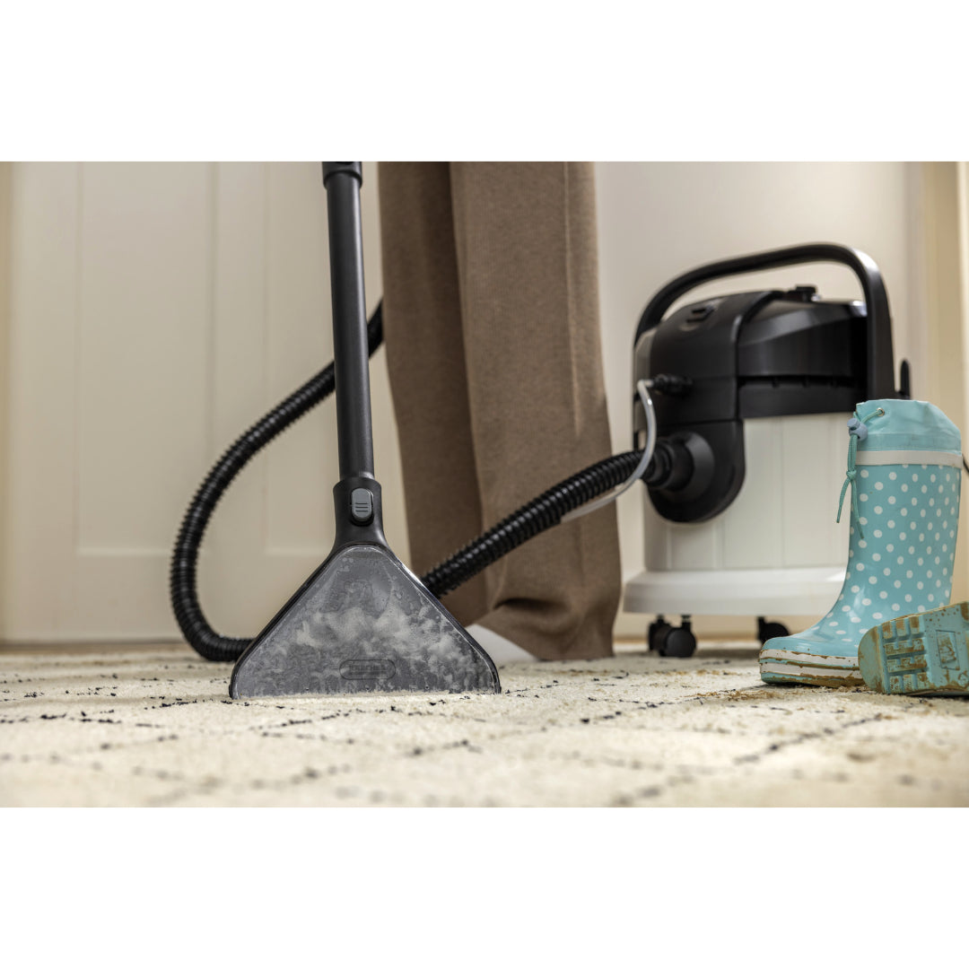 Karcher SE4 Select Carpet Cleaner Vacuum in use on a carpet with blue polka dot rain boots nearby.