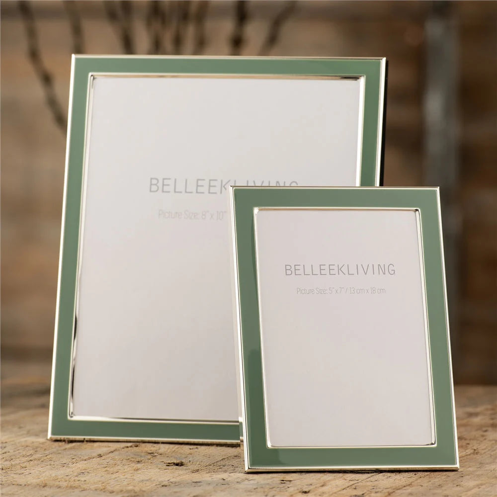 Two Belleek Teal Frame photo frames, 8x10in and 5x7in, with teal borders and silver edges on a wooden surface.