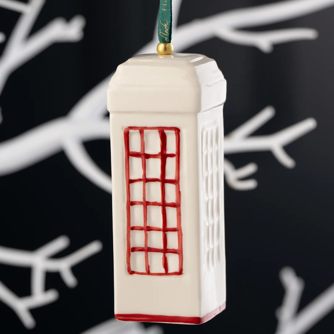 White ceramic Classic Red Telephone Box ornament with red window details hanging on a green ribbon