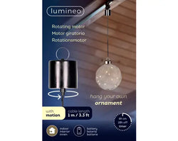 Product packaging for the Lumineo rotating motor pendant light ornament, showing a black cylindrical hanging ornament on the left and a clear spherical ornament on the right against a dark blue background with product features and icons.