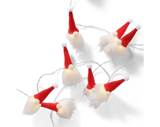 Battery-operated LED string lights with fabric Santa hats and white fluffy beards on a white background.