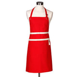 Le Creuset Cerise Chef's Apron with adjustable neck strap, deep pockets, and hand cloth loop – available at Keans