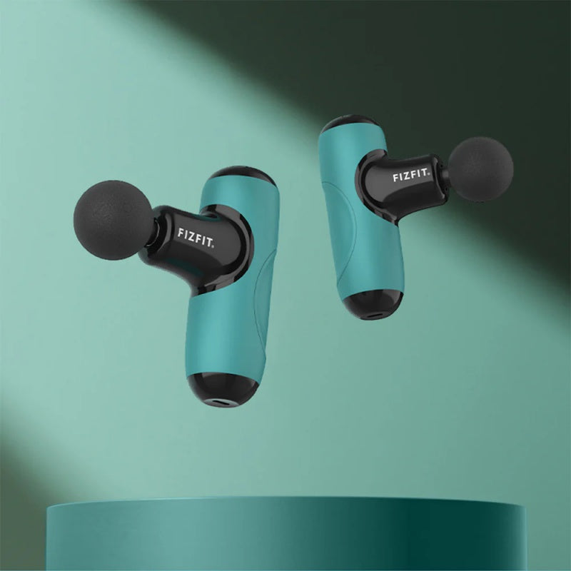 Two teal and black FizFit Massage Gun Mini Q1 devices with round massage heads floating above a teal platform.