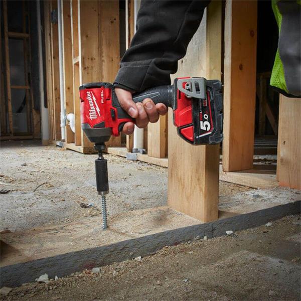 Milwaukee Shockwave Socket Adaptor attached to a drill driving a screw into wood framing.