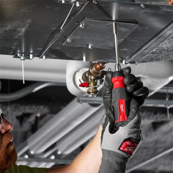 Hand using Milwaukee 14 in 1 Ratchet Multi-Bit Screwdriver to tighten screws on metal panel overhead